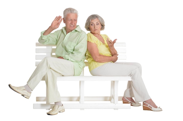 Sad senior couple sitting on bench