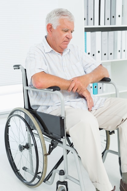 Sad senior man sitting in wheelchair