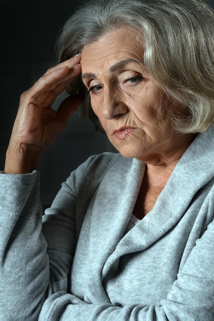 Sad senior woman posing isolated