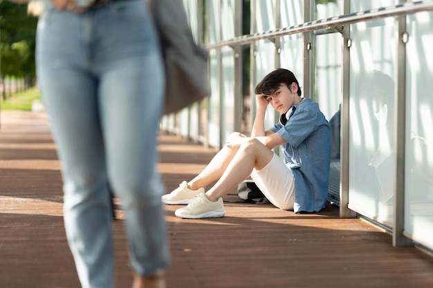 Sad teenager boy looking at girl