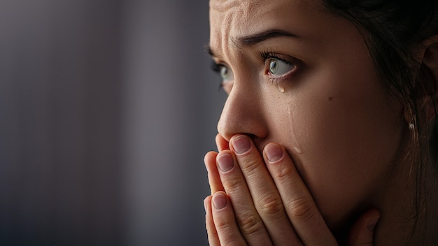 Sad unhappy grieving crying woman with tears eyes