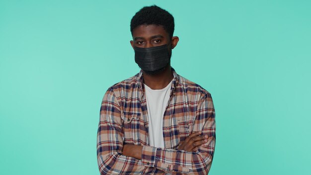 Sad unhappy man putting on face medical mask prevent respiratory Coronavirus infection flu disease
