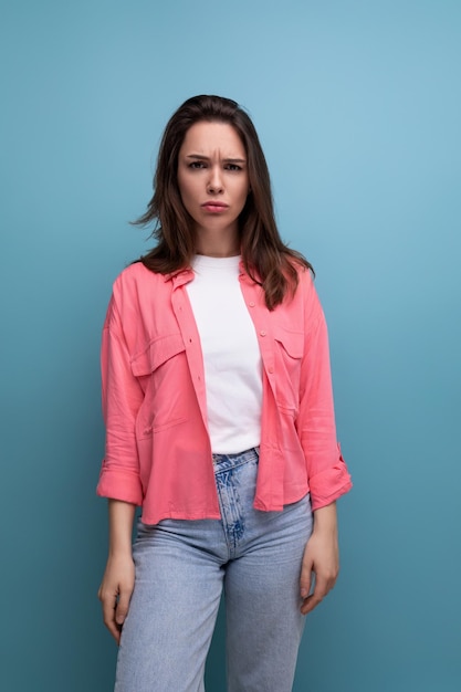 Sad upset brunette woman with below shoulder length hair isolated background