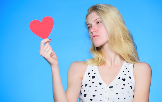 Sad woman on blue background woman with decorative heart date romantic greeting valentines day sales love and romance valentines day party secret attraction feeling depressed