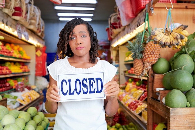 Sad woman closing store