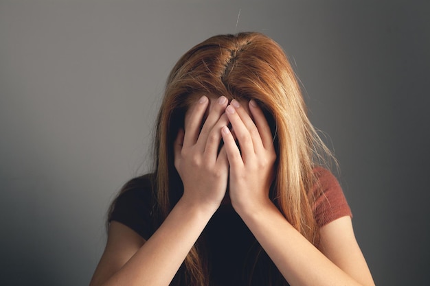 Sad woman covered her face with her hands