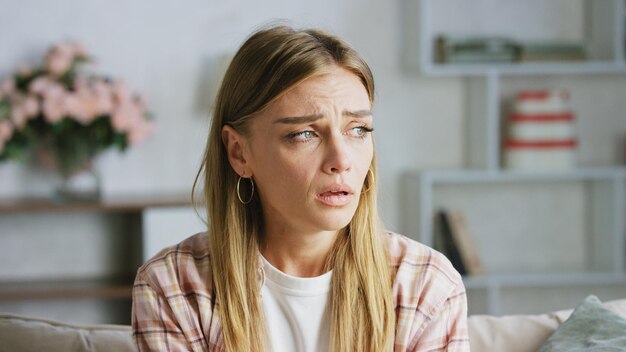sad woman crying at home feeling depressed and lonely