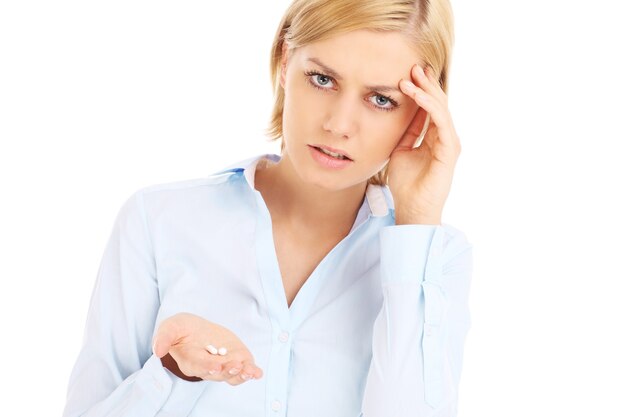 a sad woman suffering from headache over white background