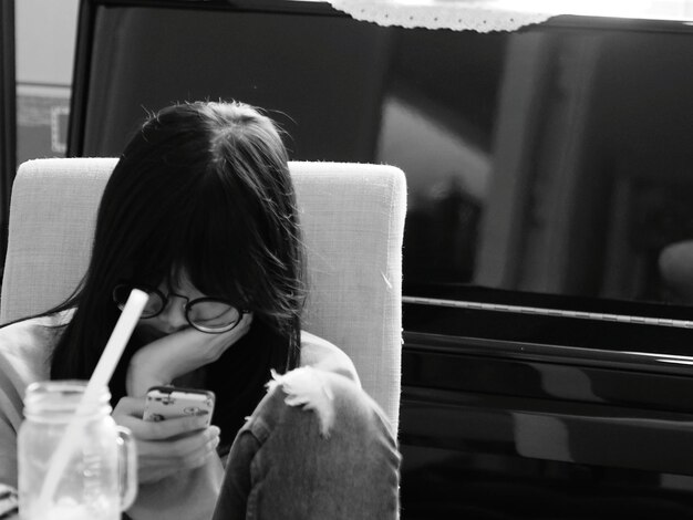 Photo sad woman using mobile phone sitting in train