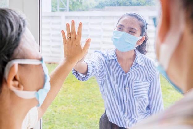 Sad woman visiting her infected parents at home