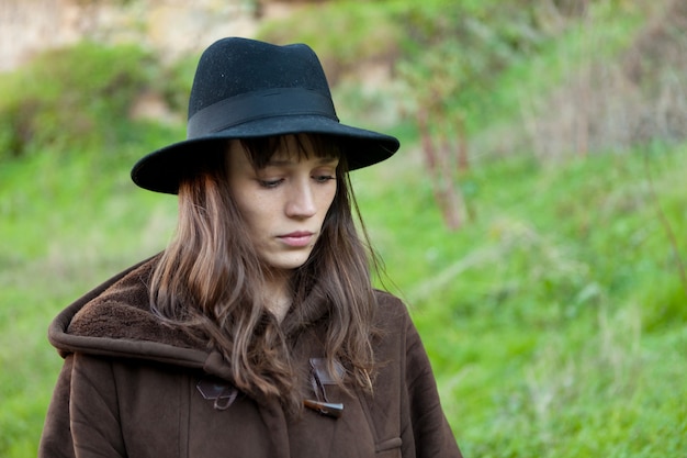 Sad woman with black hat 