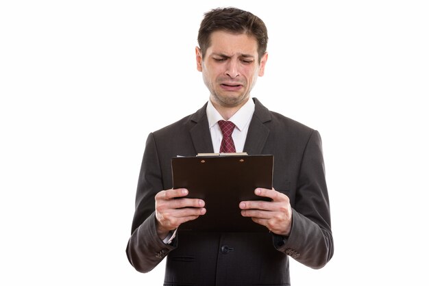 sad young businessman reading on clipboard