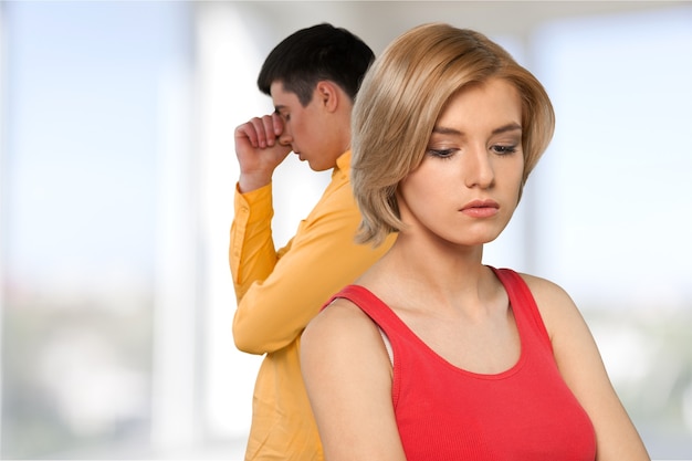 Sad young couple isolated on white