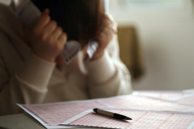 A sad young girl suffers from a loss after looking the unlucky result of the lottery gambling The concept of losing the lottery and spend money