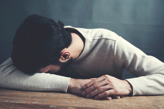 Sad Young Man on the Table