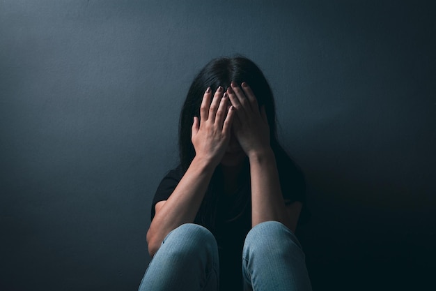 Sad young woman sitting on the floor