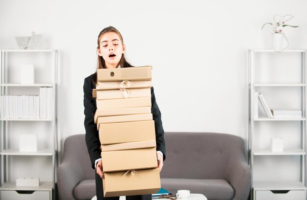 Photo sadness depressed businesswoman holding many folders with the documents frustration secretary girl