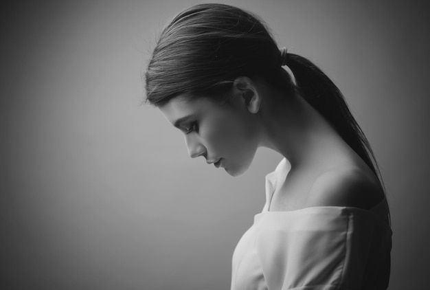 Depression. Close Up Portrait Of A Sad Woman Looking Down, Profile View,  Isolated On White Background, Black And White Stock Photo, Picture and  Royalty Free Image. Image 58154341.