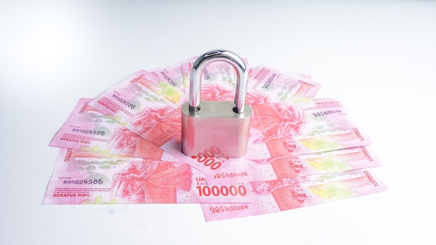 Safe money Indonesia Money Rupiah and padlocks isolated on a white background Selective Focus