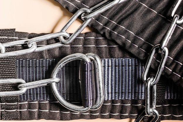 Safety belt for working at height with locks. Professional safety equipment for mountaineering and construction. Safety precautions. Close-up.