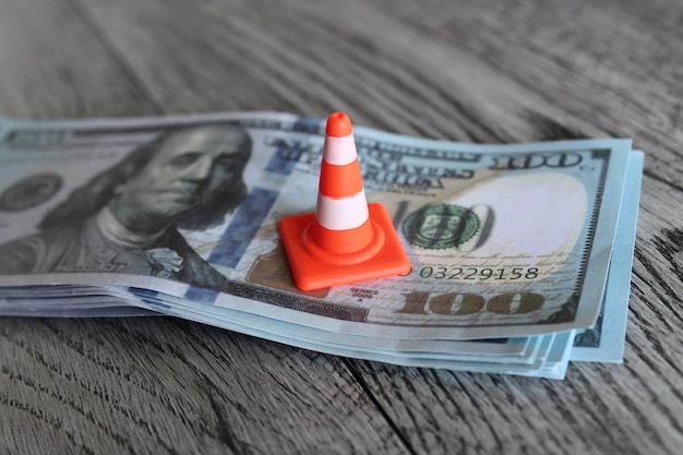 Safety cone on top of money revise investment money saving plan\
business and financial concept