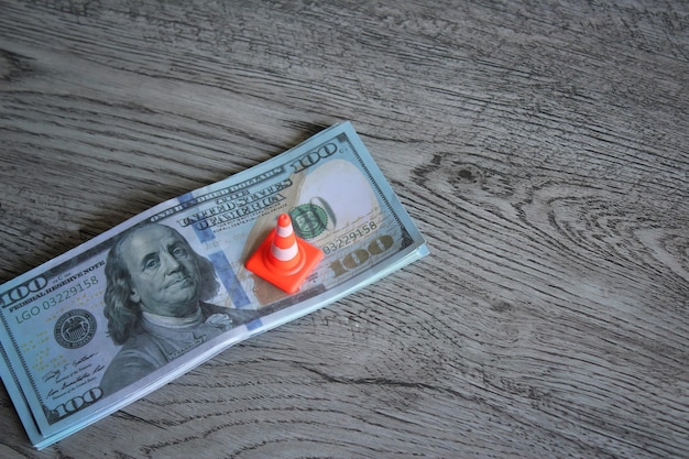 Safety cone on top of money revise investment money saving plan\
business and financial concept