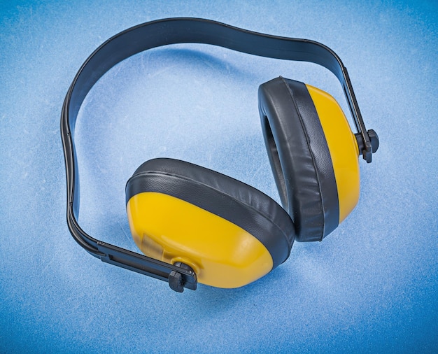 Photo safety ear muffs on blue background construction concept