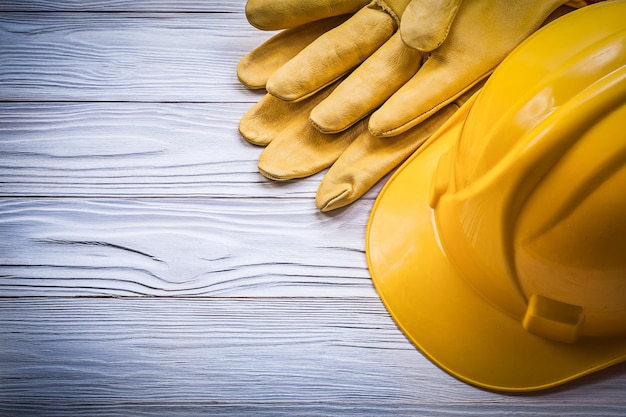 Safety gloves hard hat on wooden board construction concept