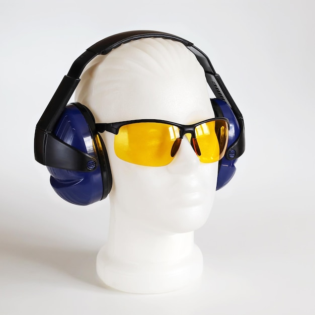 Safety headphones protection of hearing from noise protective glasses head of mannequin