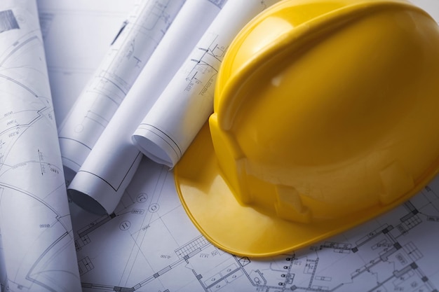 Safety Helmet And Construction Plans Close-up