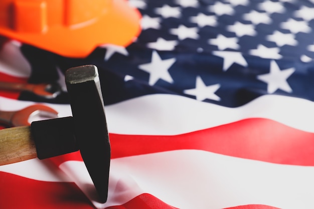 Safety helmet and hammer on american flag