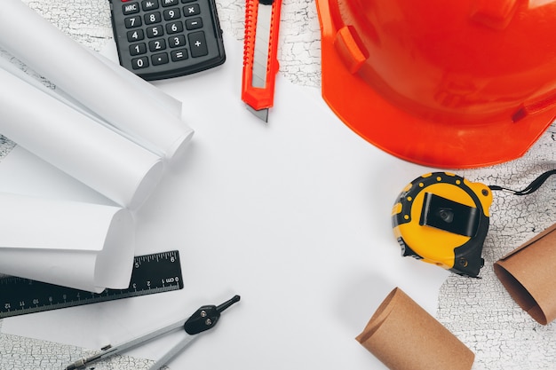 Safety helmet and Scrolls of engineering drawings and supplies