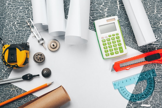 Safety helmet and Scrolls of engineering drawings and supplies