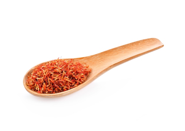 Safflower dried in wood spoon