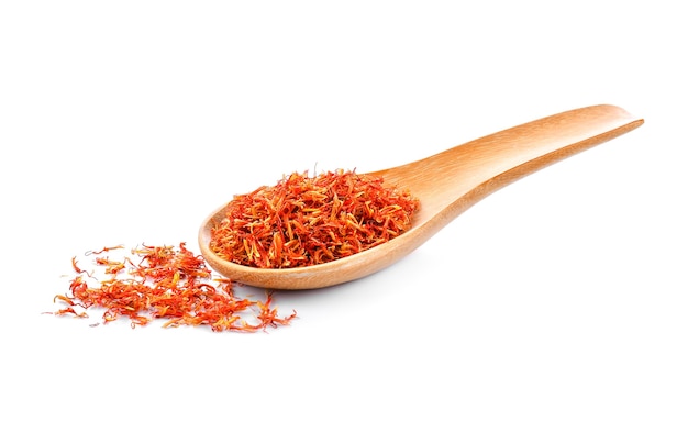 Safflower in a wooden spoon