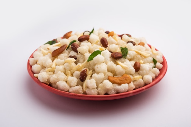 Sago or sabudana chivda is sweet and spicy deep fried farsan\
for upwas or vrat diet or fasting food, served in a bowl