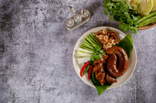 Sai Aua (Northern Thai Spicy Sausage) on a wooden surface