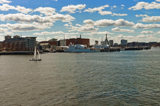 Sail boats and ship in Charles River and Leonard P Zakim Bunker Hill Memorial Bridge with the skyline of Boston, Massachusetts, USA.