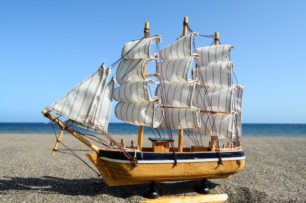 Sail Ship Toy Model in the Beach Sand Close-up