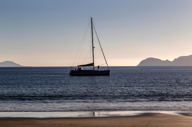 Sailboat anchored near a beach in the evening Vigo estuary Galicia Spain