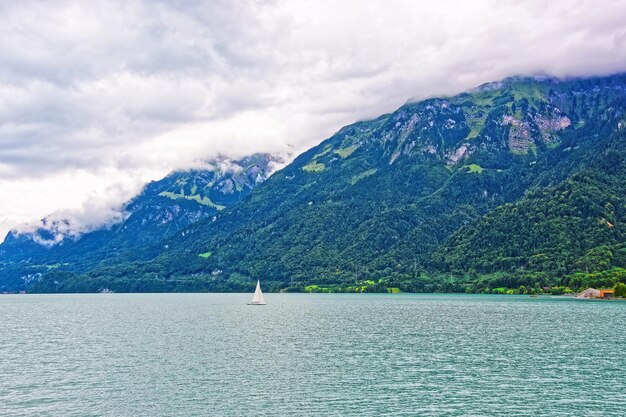 Sailboat in Lake Brienz and Brienzer Rothorn mountain at Interlaken in Canton of Bern in Switzerland