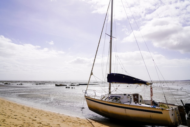 Sailboat at low tide at ArÃÂ¨s in Arcachon Bay in Gironde southwest France