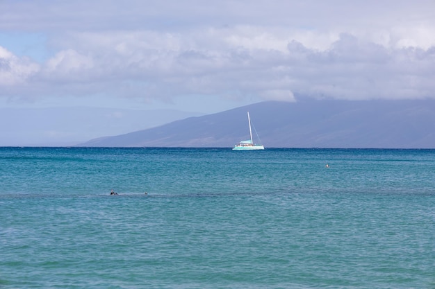 Sailboat in the open sea calm sea sailing luxury summer\
adventure active vacations maui hawaii