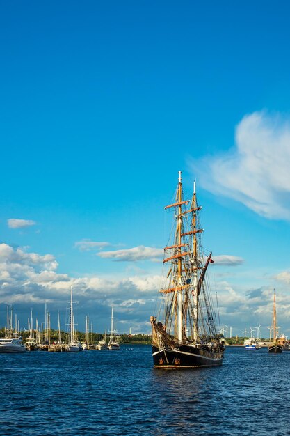 Sailboat sailing on sea against blue sky