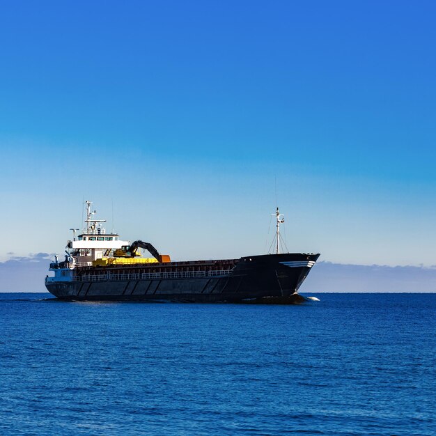 Sailboat sailing on sea against clear blue sky