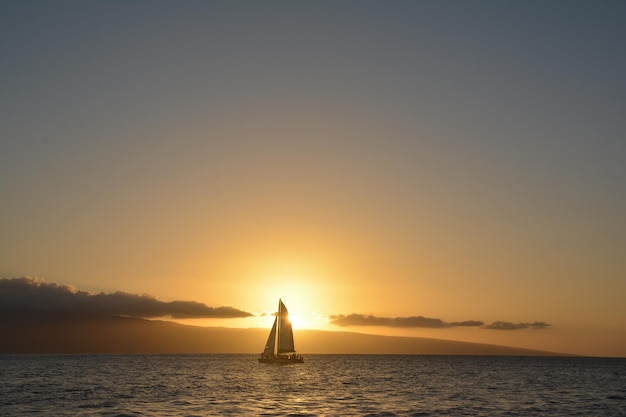 sailboat on sea against sky during sunset