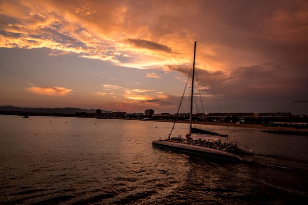 sailboat in sea during sunset