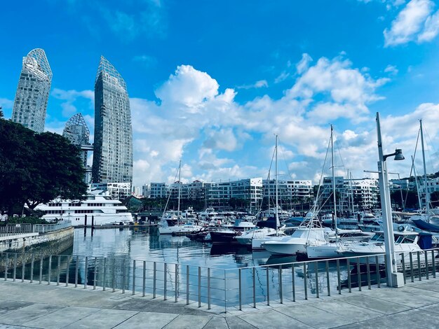 Sailboats in city against sky