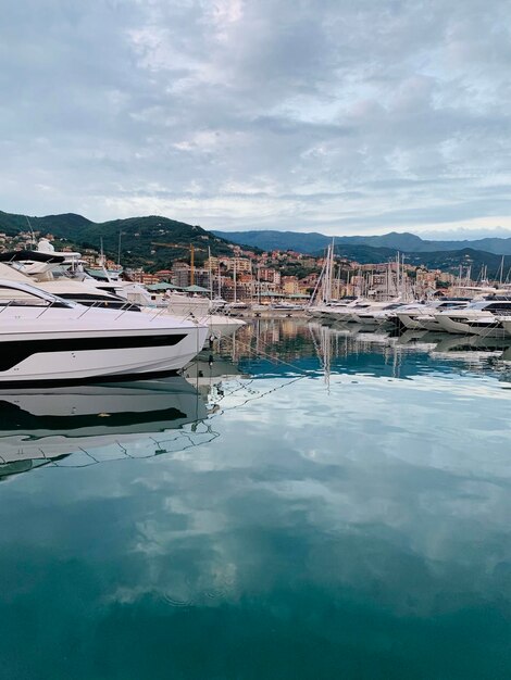 Sailboats in marina against sky