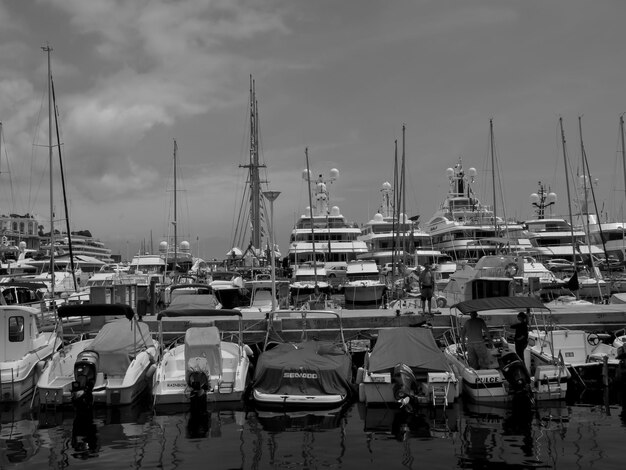 Sailboats moored at harbor against sky